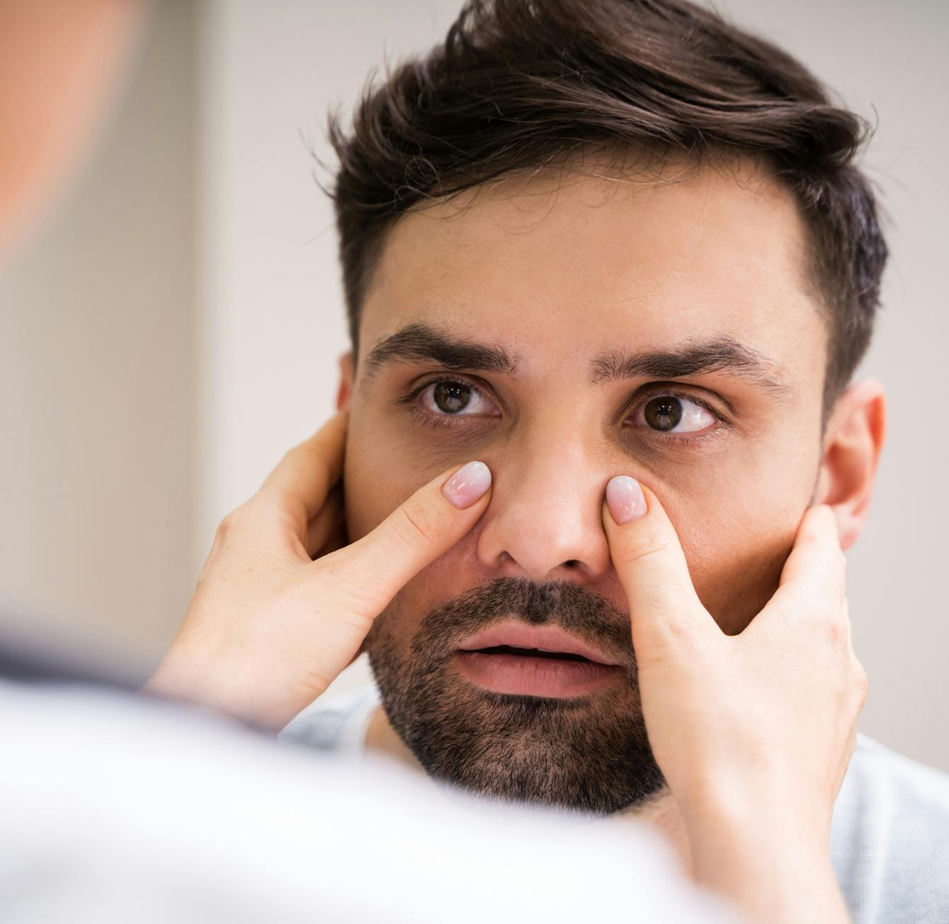 doctor checking male patients sinuses