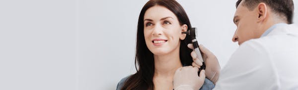 Dr looking into woman's ear