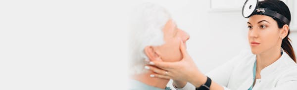 doctor checking male patient's face