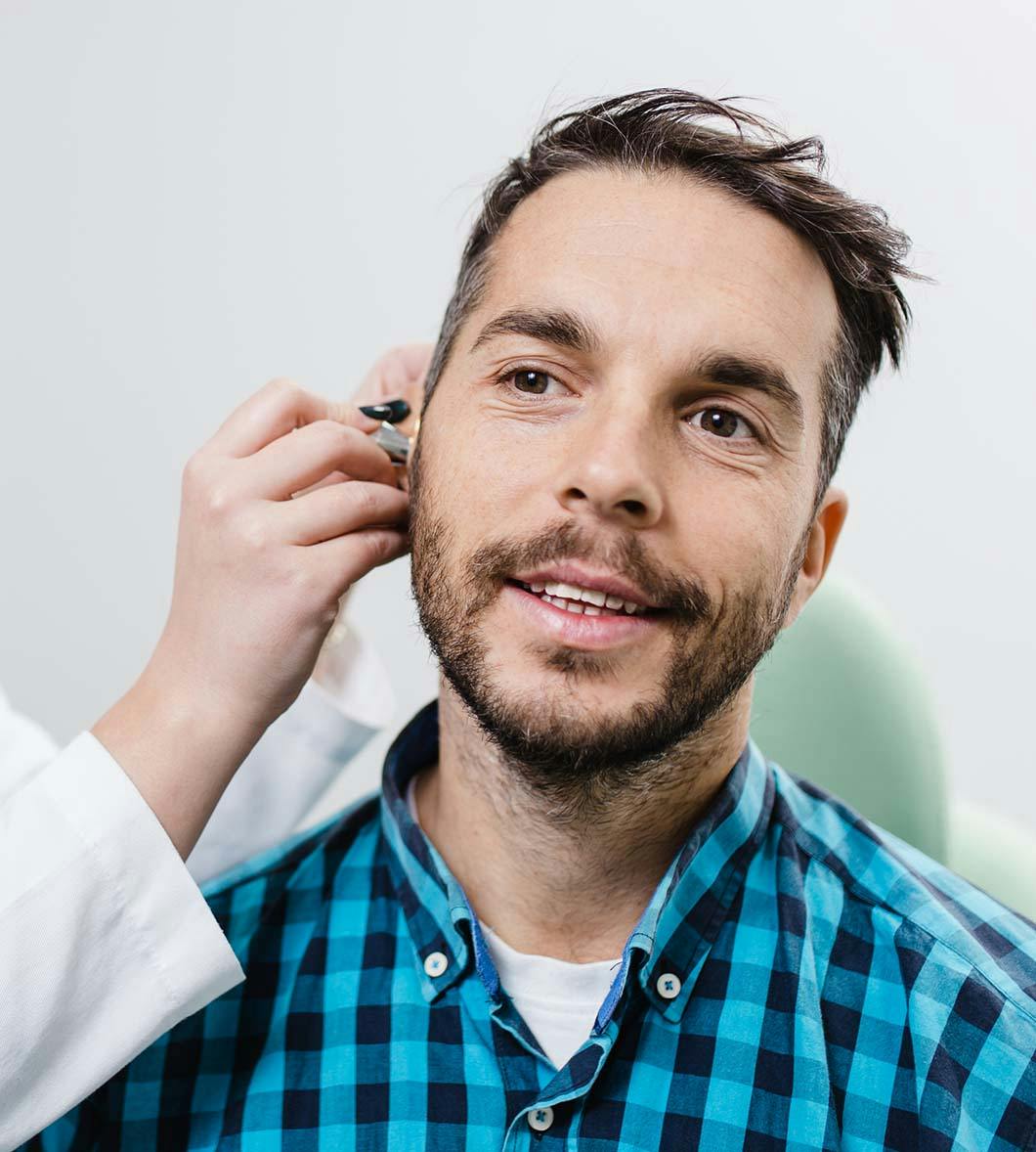 man having his ear evaluated