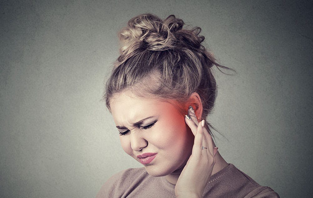 woman experiencing ear discomfort