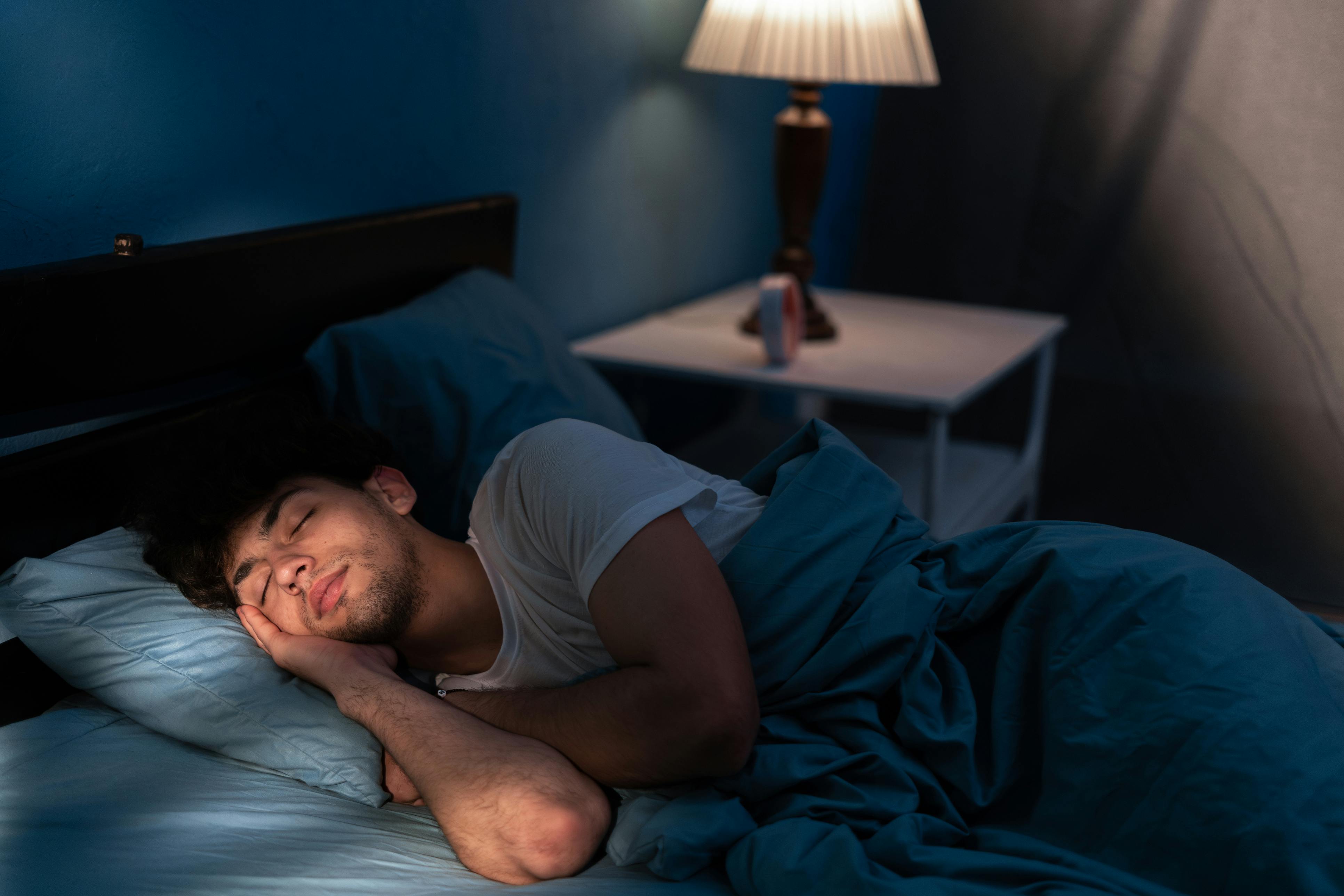 man sleeping in a bed