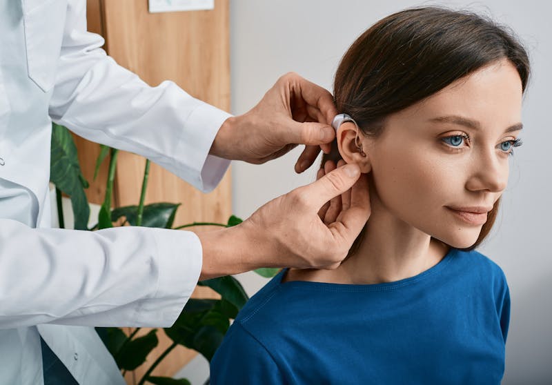 Woman being fit for hearing aid