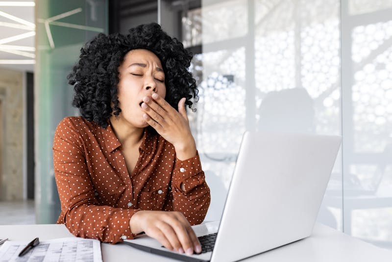 woman yawning at work