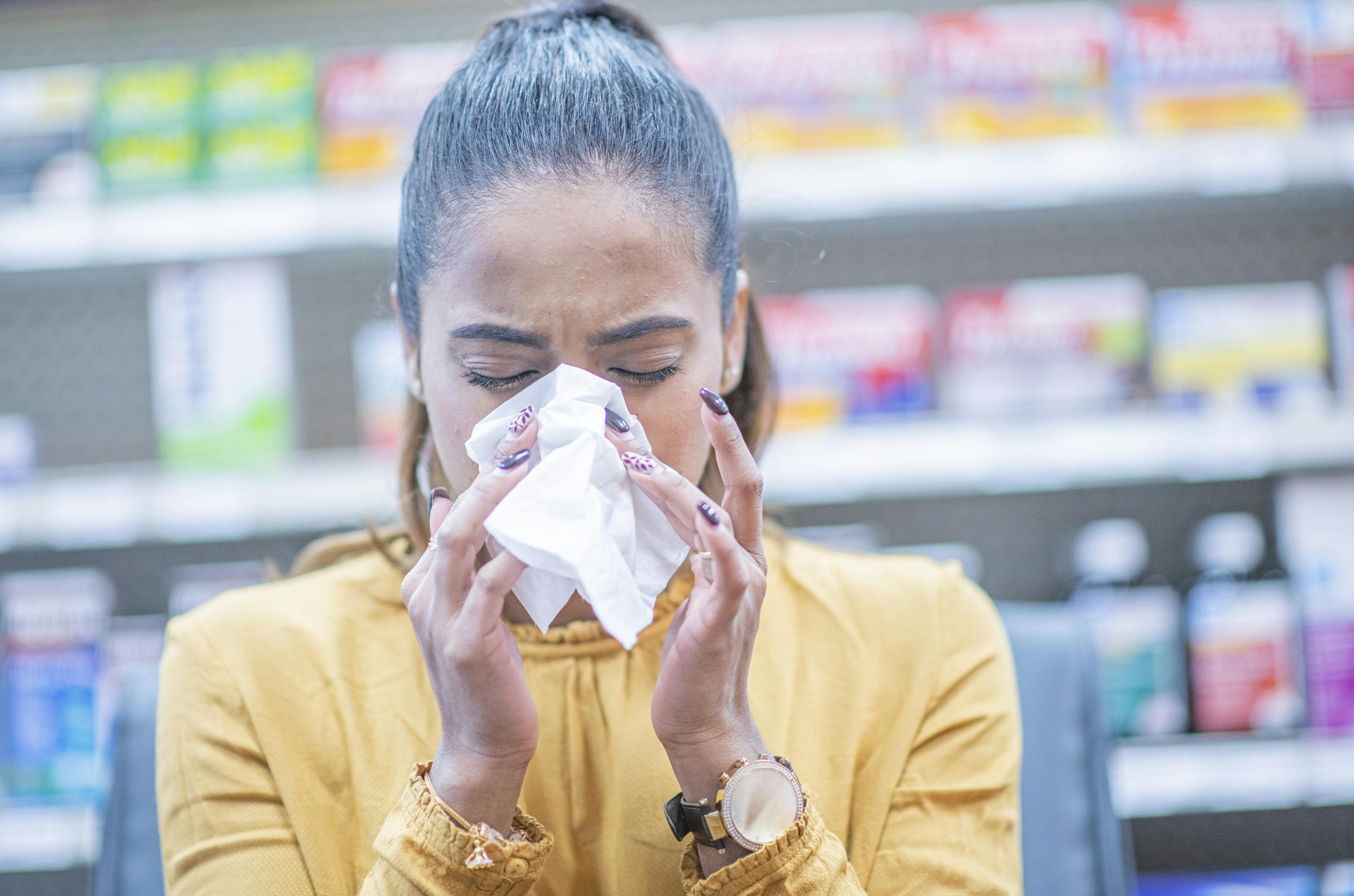 woman blowing her nose