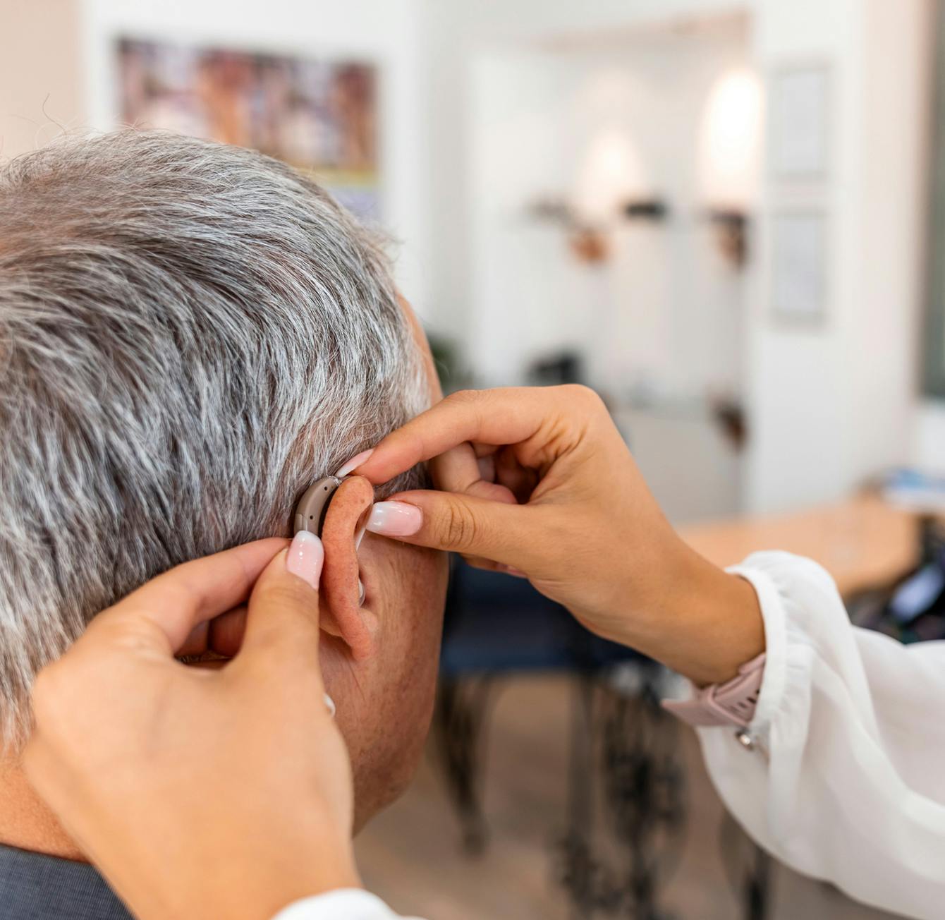 person getting hearing aids put on