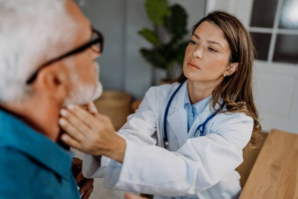 Man Getting His Throat Checked