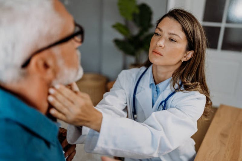 Man Getting His Throat Checked