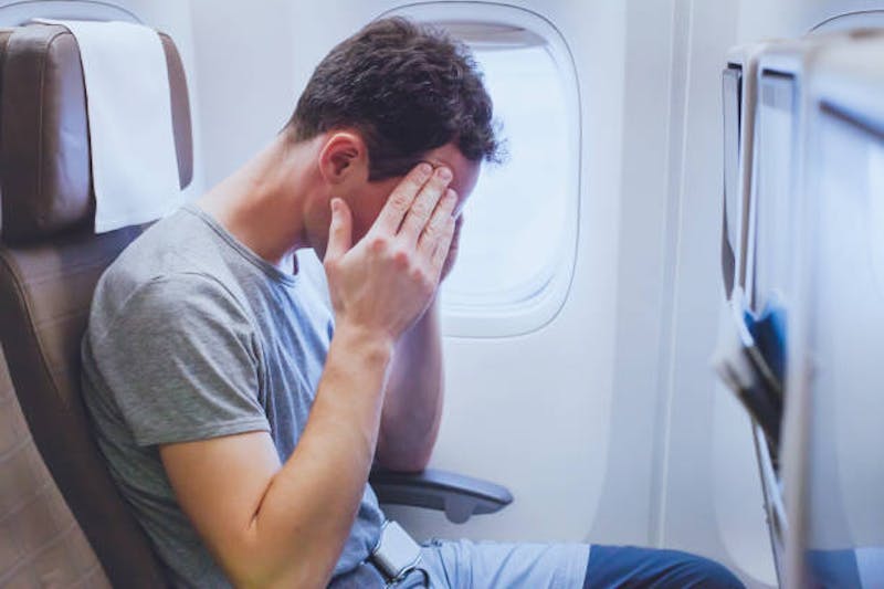 Man in discomfort on a plane