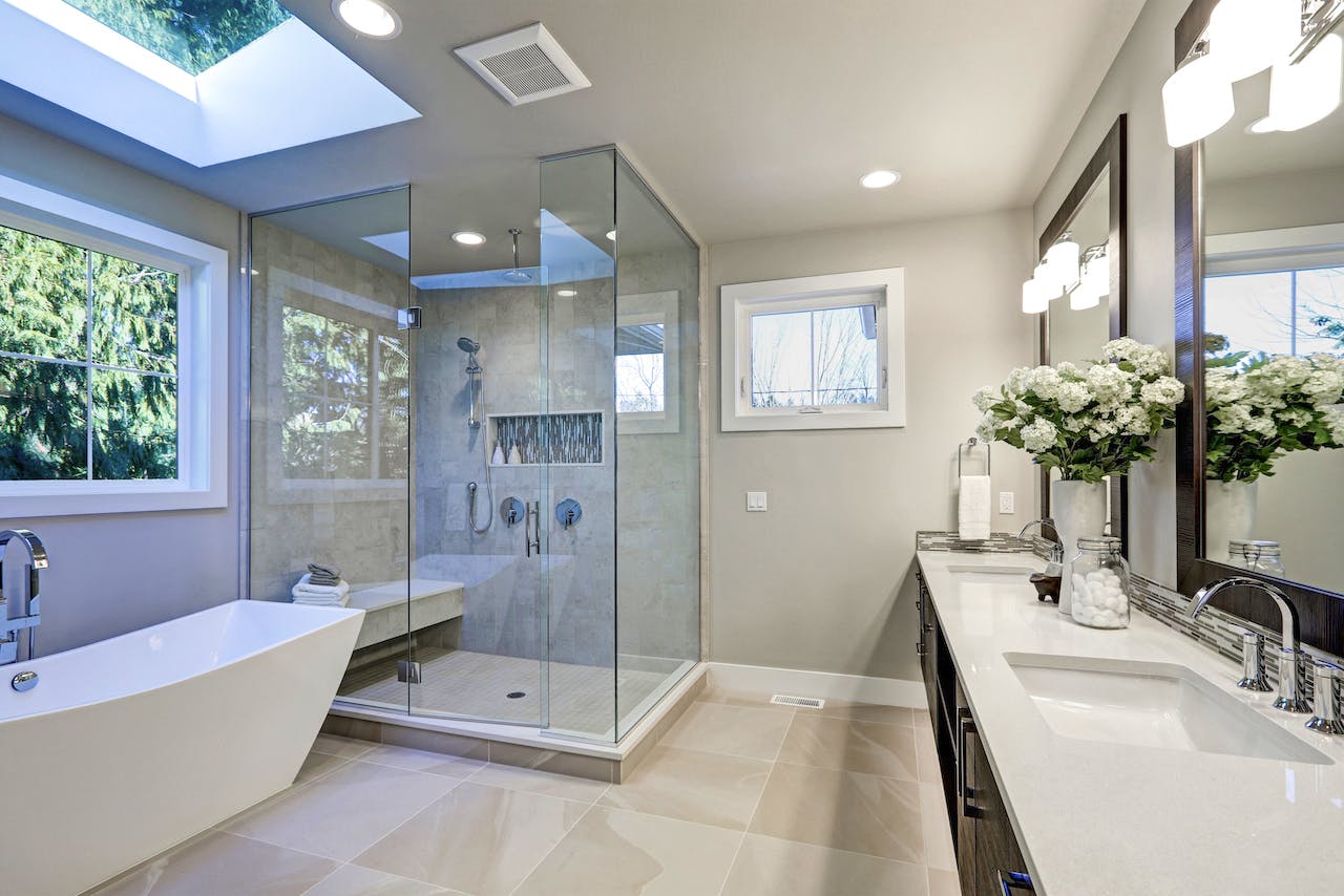 A frameless shower door showcasing sleek, transparent glass paneling, enhancing the spaciousness and modern aesthetic of the shower enclosure.