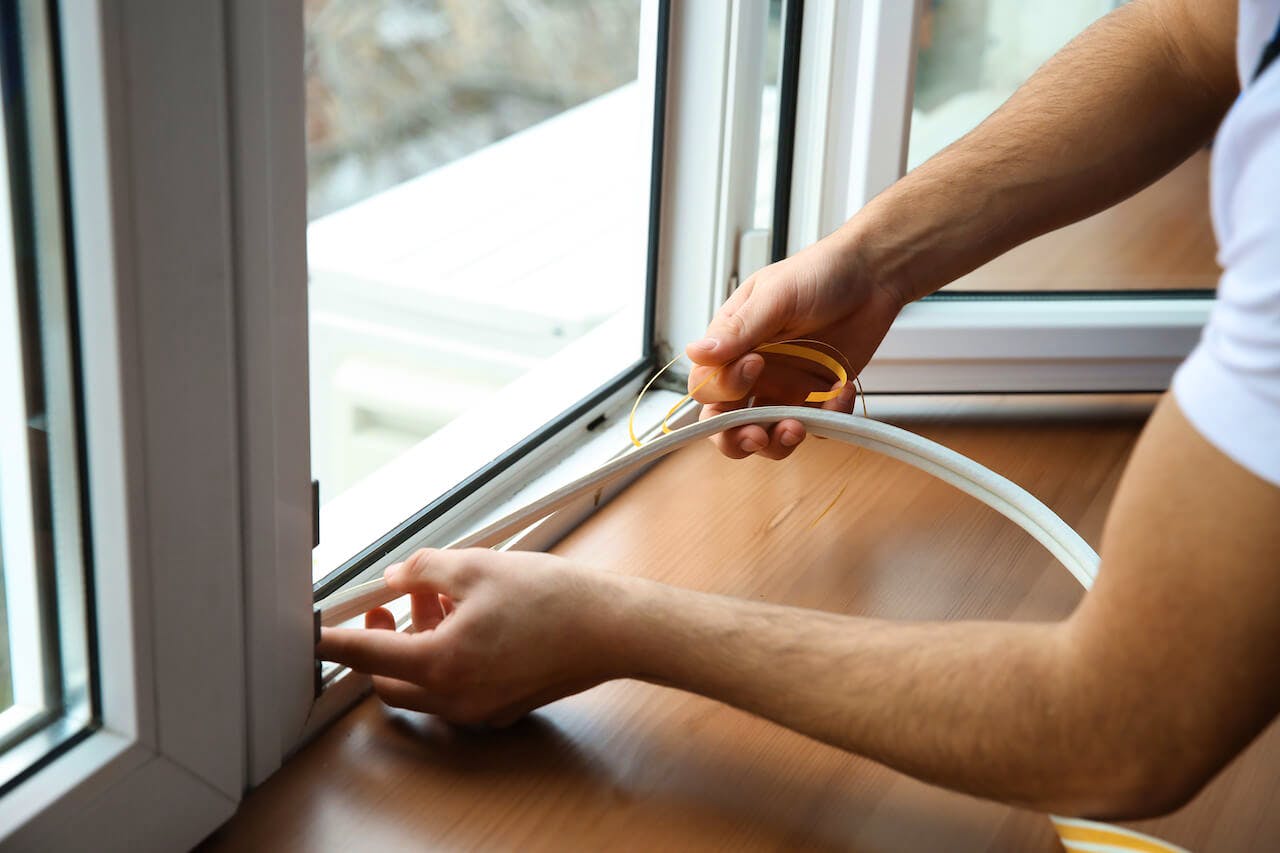 Weatherstripping window to prevent drafts.