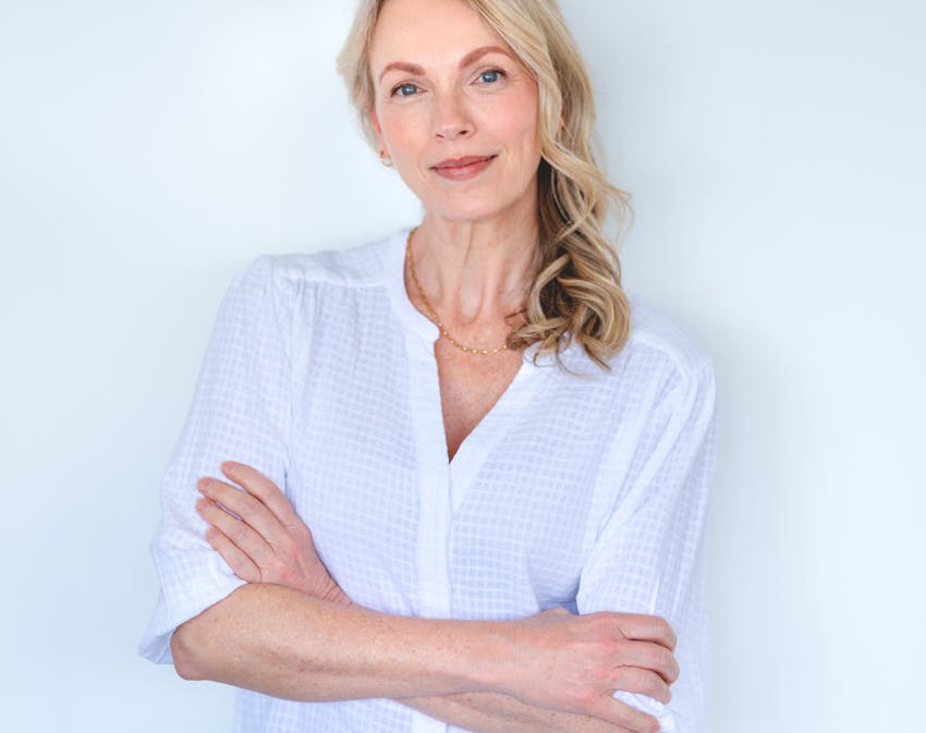 Woman in white looking at camera