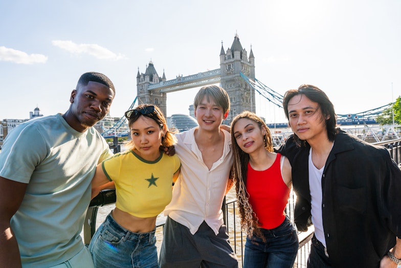 Mixed high school group posing in front of Tower Bridge in London
