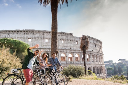 Students on bikes in front of The Colosseum in Rome