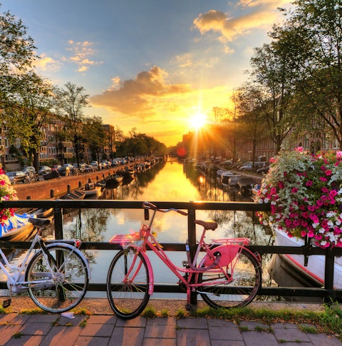 Amsterdam at sunset featuring canals and bikes