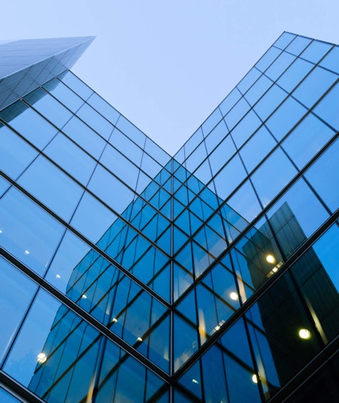 Upward view of a tall glass building in London