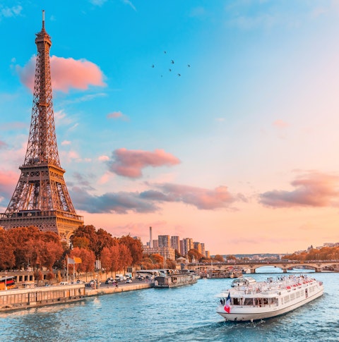 Early evening image of a riverboat passing the Eiffel Tower