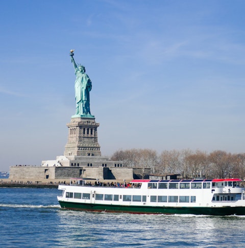 Riverboat passing the Statue of Liberty on Liberty Island, New York