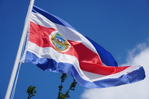 Upward view of the Costa Rica flag blowing in the wind on a flag pole