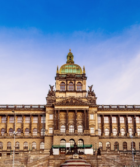Looking up at the Národní Muzeum from Wenceslas Square in Prague with blue skies