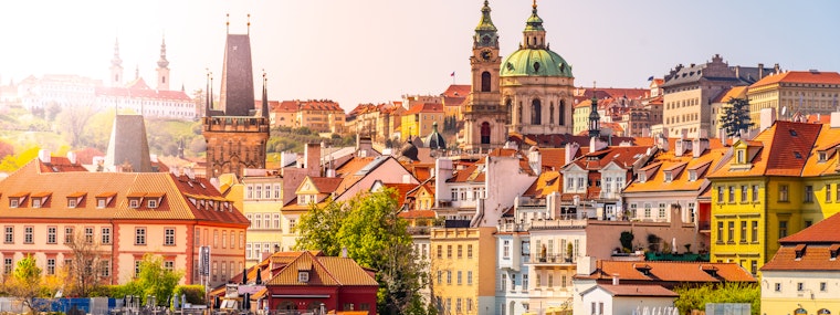 Sunny view of Lesser Town, Prague featuring colourful buildings and water