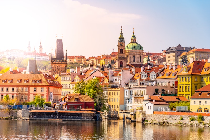 Sunny view of Lesser Town, Prague featuring colourful buildings and water