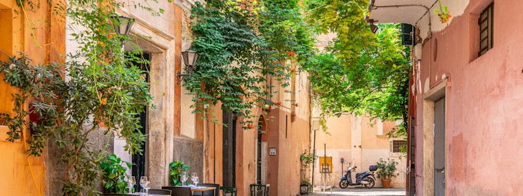 Cozy street with plants in Trastevere, Rome, Europe.