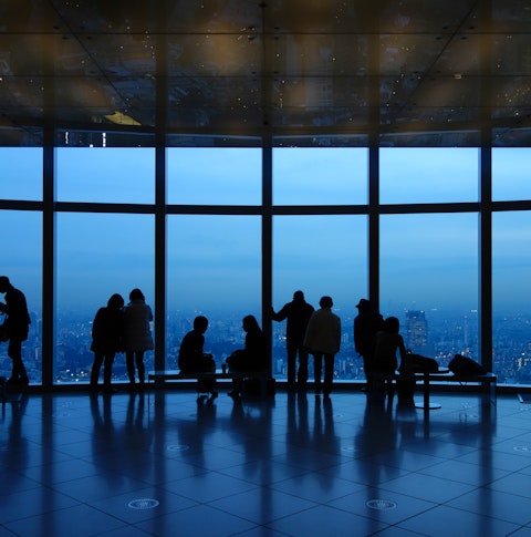 Silhouette of couples looking at a twilight view of Tokyo city from the Mori Observation Deck