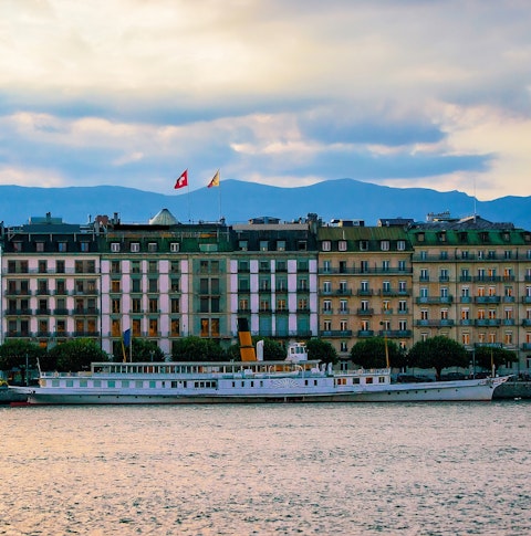 Wide shot of a river cruise along Lake Geneva
