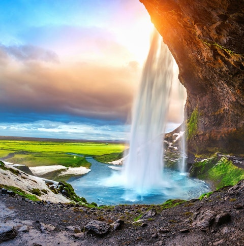 View at the bottom of Seljalandsfoss waterfall in the sun