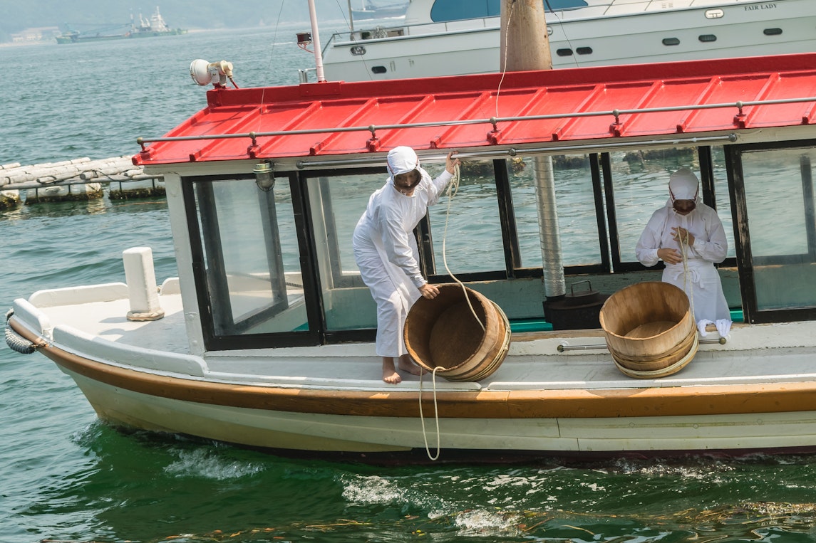 A fishing boat with Ama divers onboard