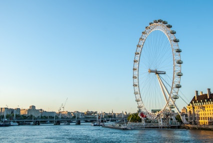 Blue skies dominate this photo of the London Eye at sunset