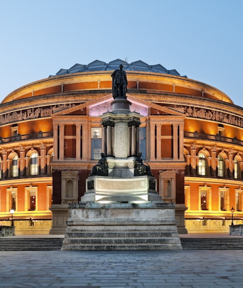 A lit-up Royal Albert Hall at dusk in London