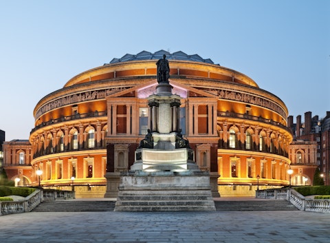 A lit-up Royal Albert Hall at dusk in London