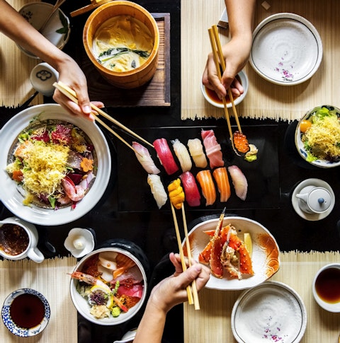 A table of ramen, sushi, bao and various other Japanese food items