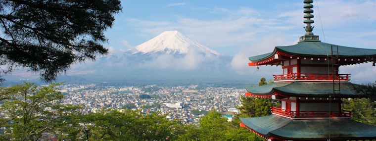 Long range shot of Mount Fuji in Japan overlooking a Japanese village