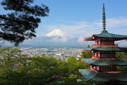 Long range shot of Mount Fuji in Japan overlooking a Japanese village