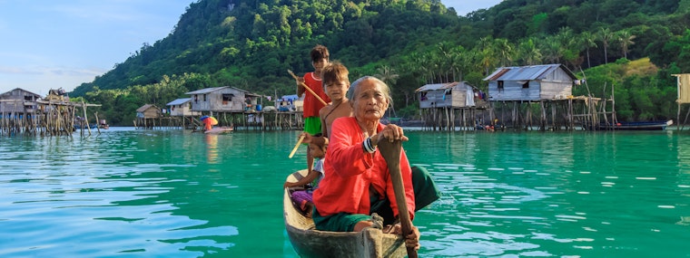 Woman and children on a boat, Malaysia