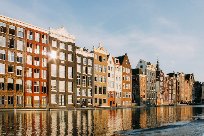 Amsterdam coloured buildings at daytime next to a canal