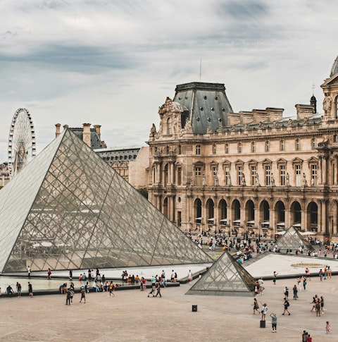 Long range shot of the glass pyramid at the Louvre Museum in Paris