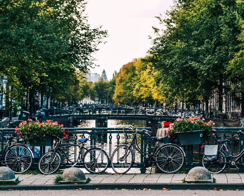 View across one of the canals in Amsterdam with bikes in the foreground
