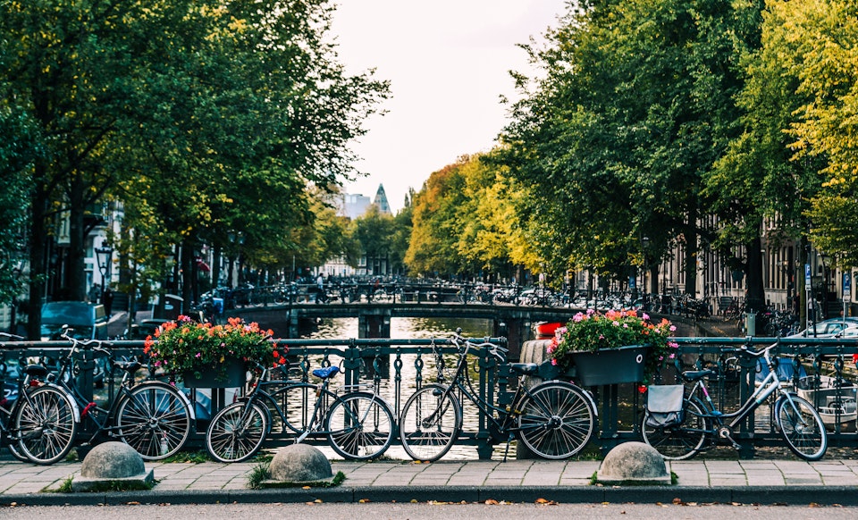 View across one of the canals in Amsterdam with bikes in the foreground