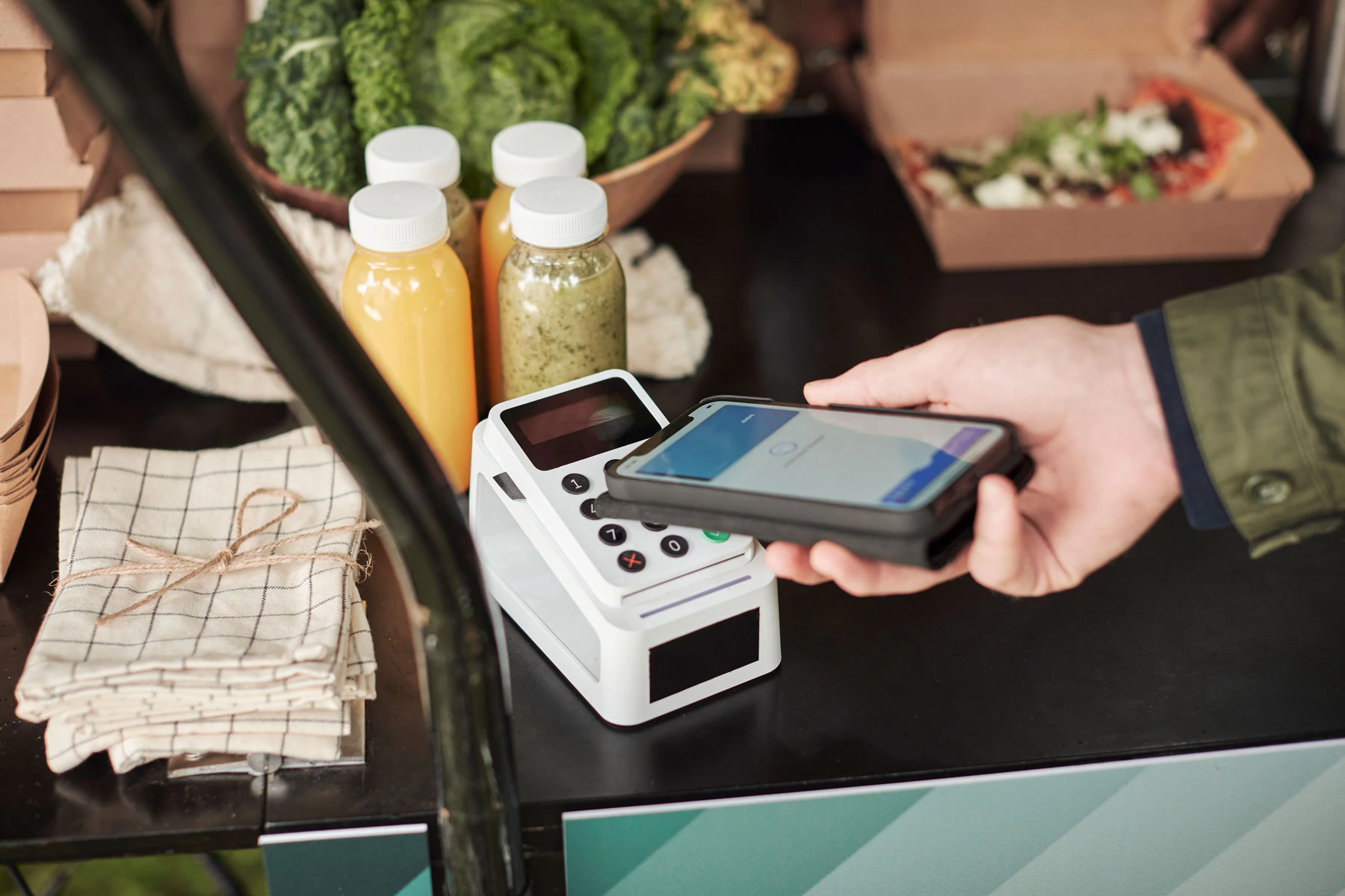 A person paying with a creditcard on his phone