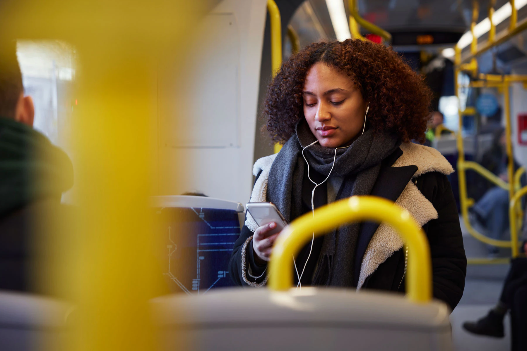 Woman on the bus watching her phone