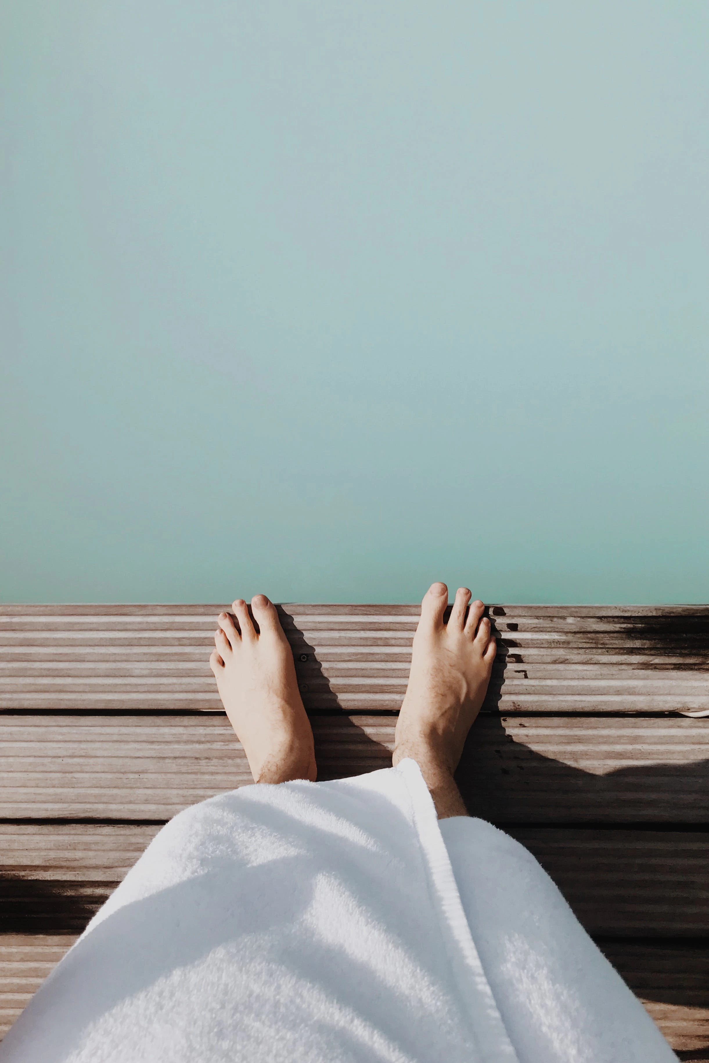 Feet on a wooden jetty