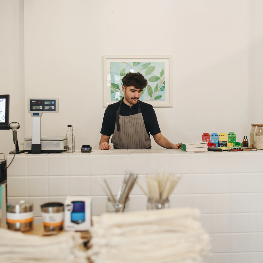 Man working the till in a store