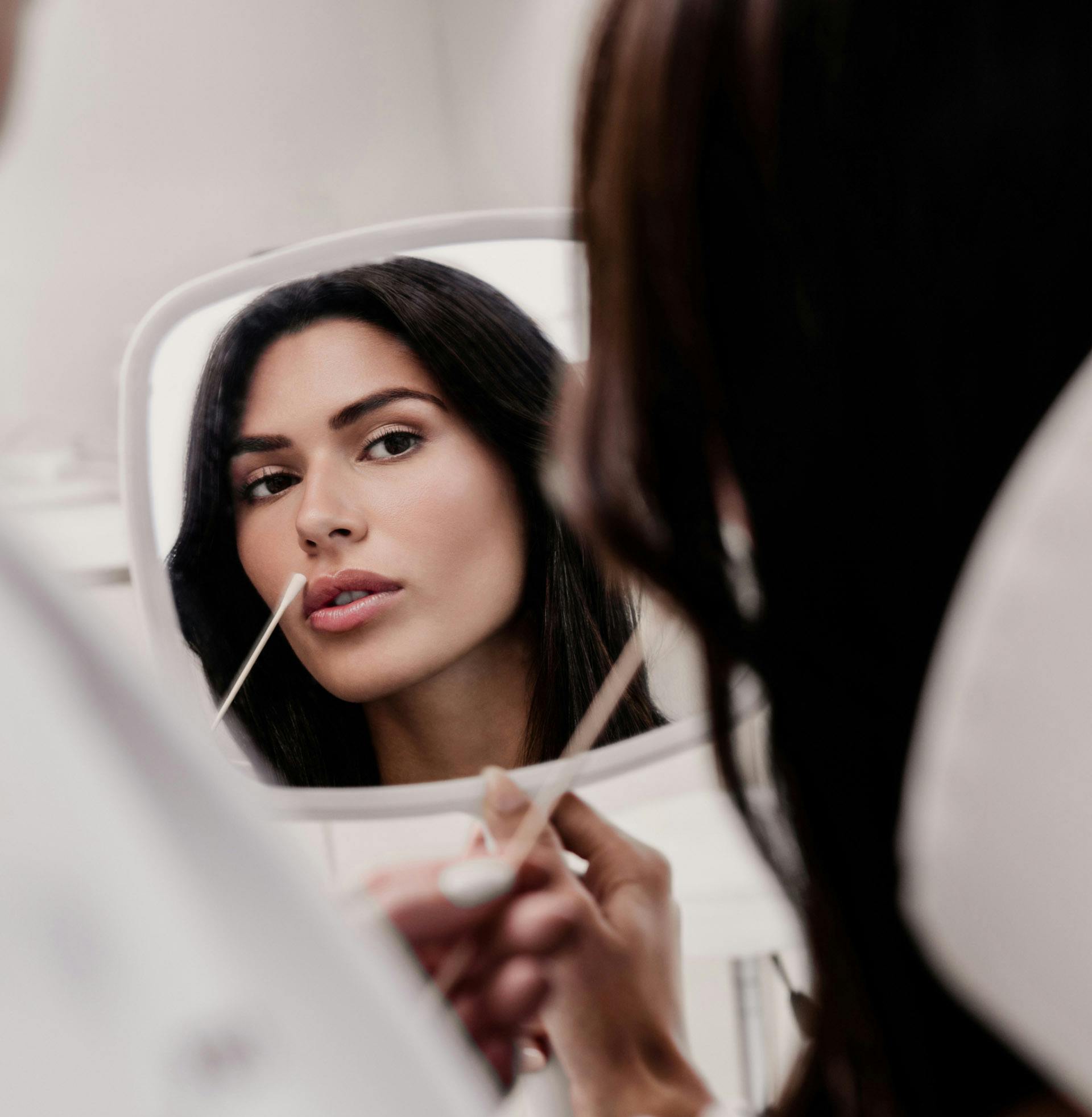 woman looking in to a mirror