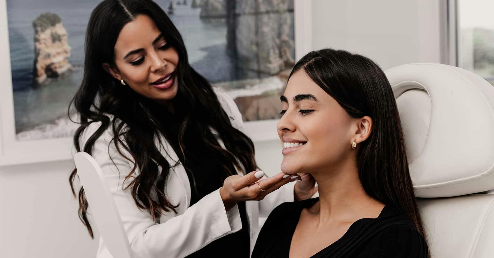 Doctor studying womans face during consultation