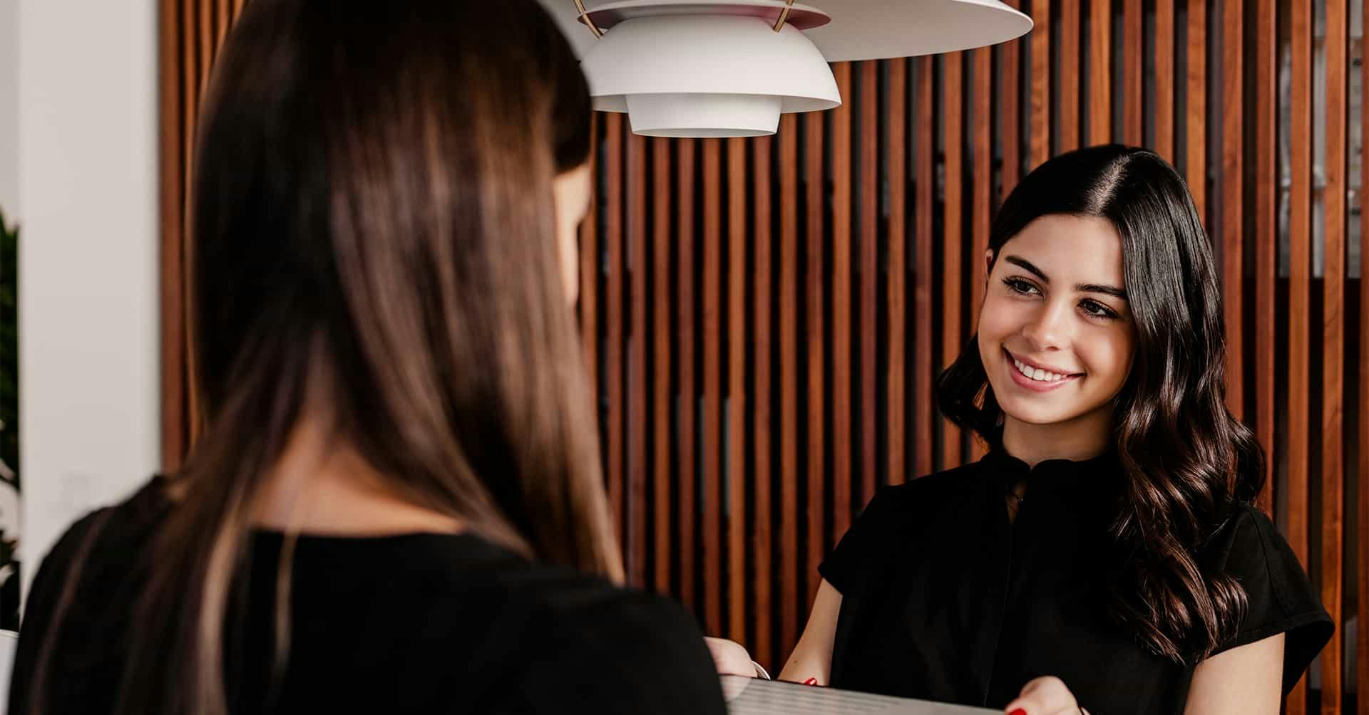 A woman checking in at the front desk