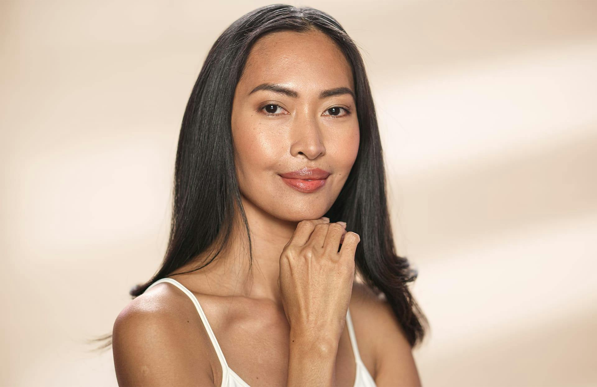 Woman smiling with hand on her chin